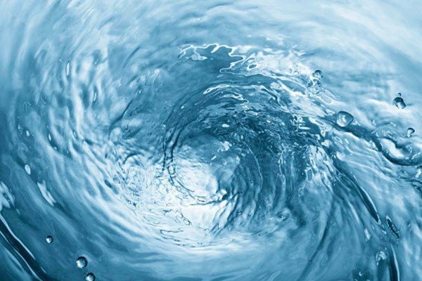 Người nuôi đang khuấy nước thủ công trong hồ cá bằng một vật dụng đơn giản